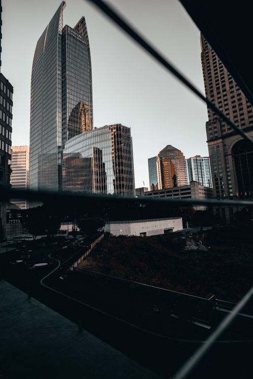 Free Captivating view of modern skyscrapers reflecting warm sunset hues in an urban cityscape. Stock Photo
