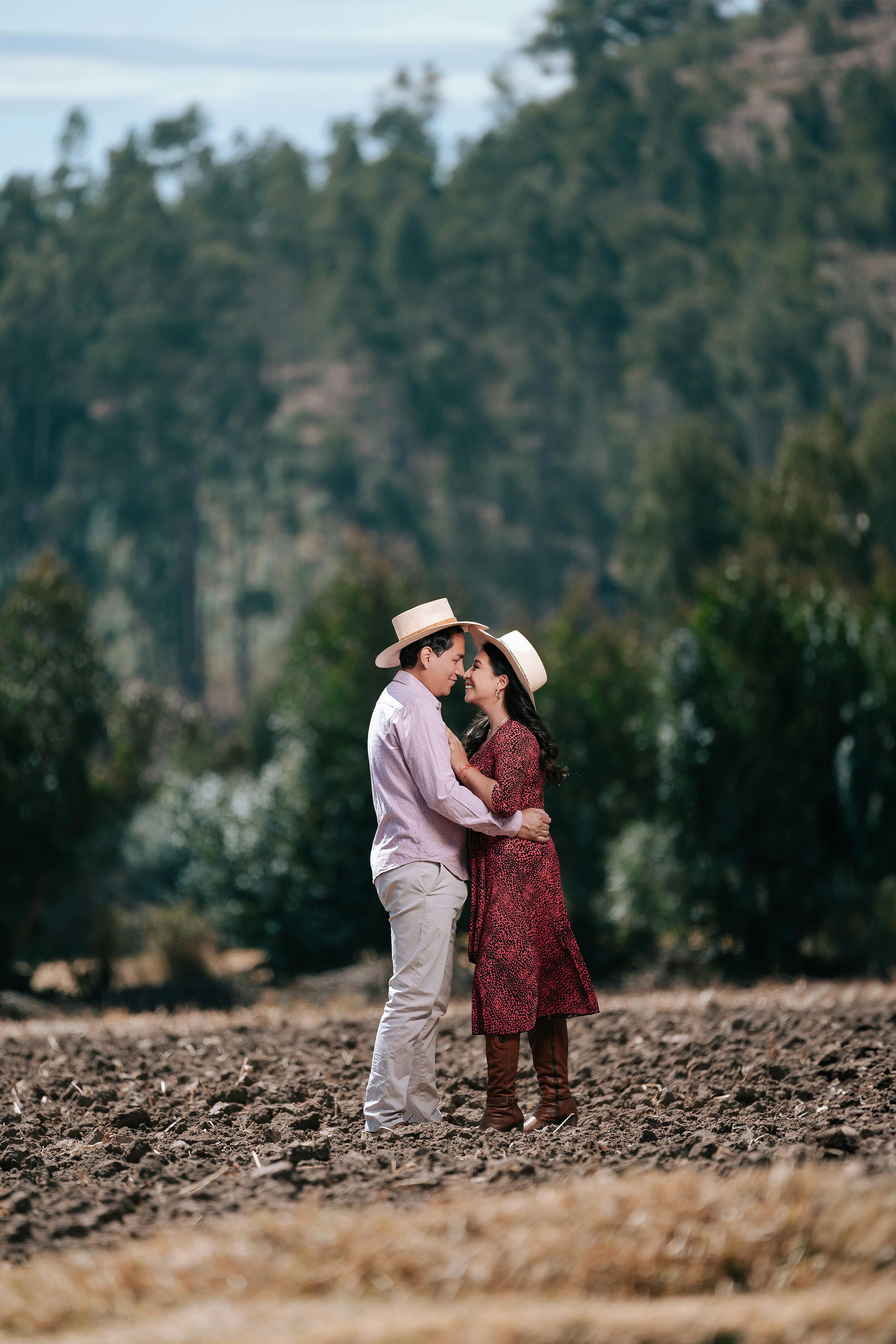 Smiling Couple in Hats Standing and Embracing ?? Free Stock Photo