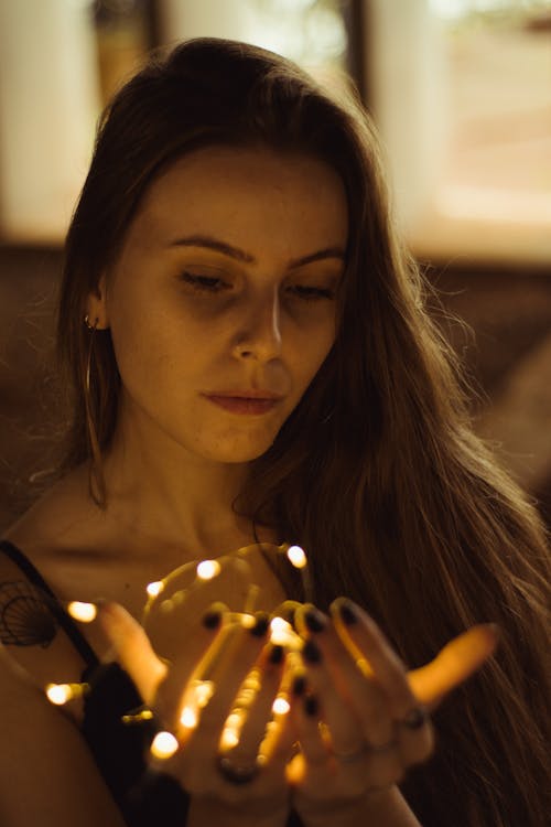 Woman Holding String Lights