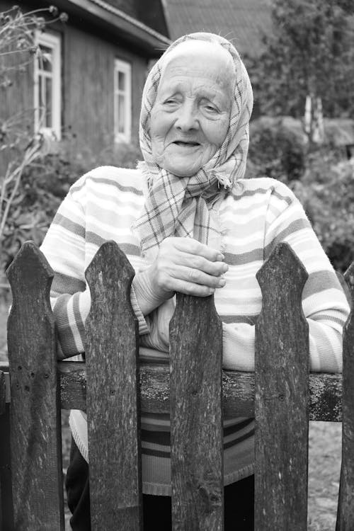 Elderly Woman behind Fence
