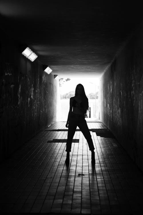 Silhouette Of Woman Standing On Hallway