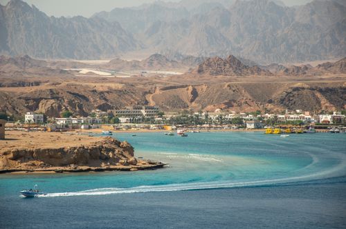 Free Aerial view of Sharm El Sheikh coastline with turquoise sea and mountainous backdrop. Stock Photo