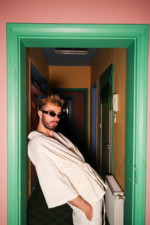 Young Man with Sunglasses Posing in Doorway