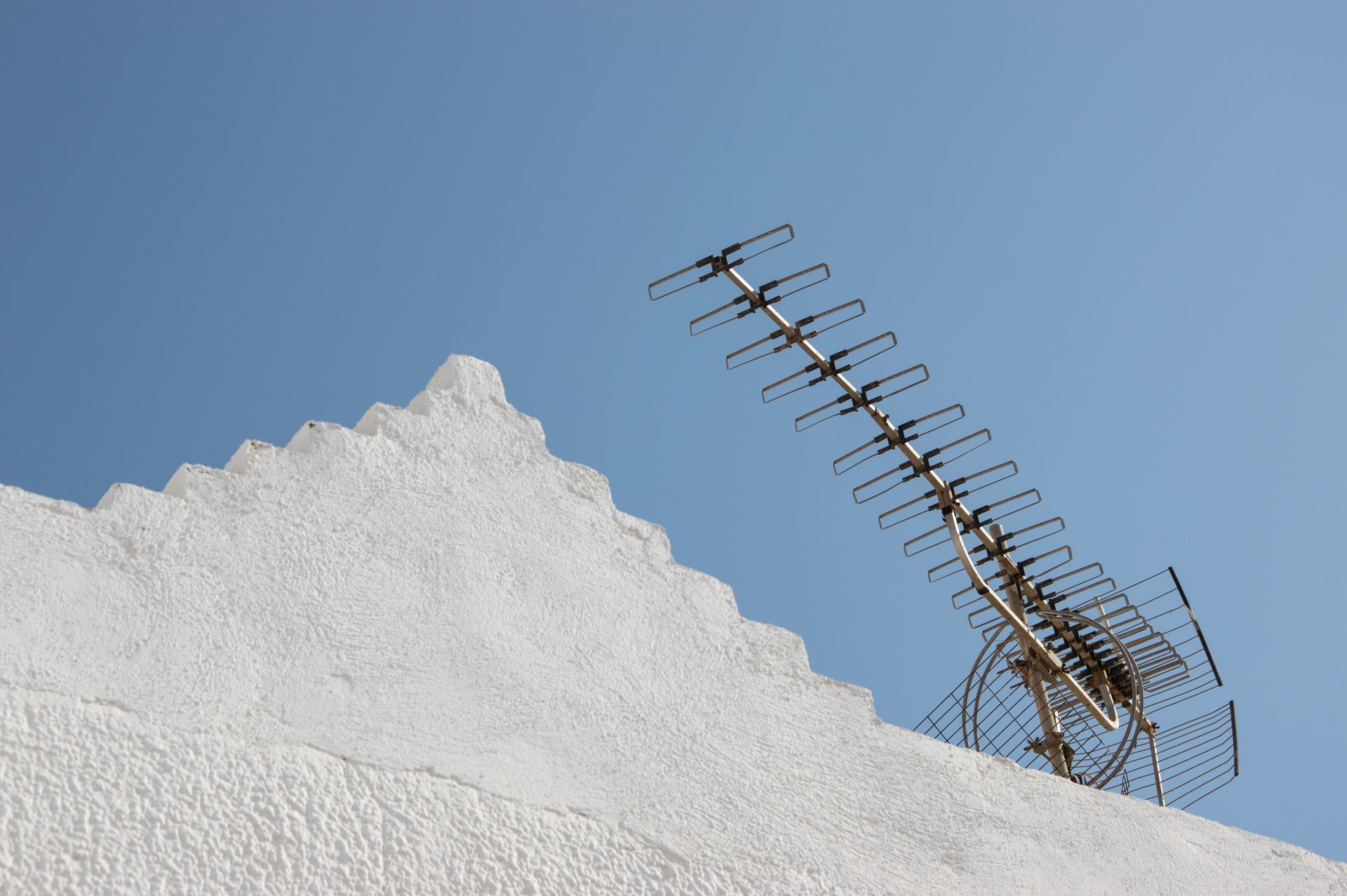 Antenna on the Roof under Blue Sky