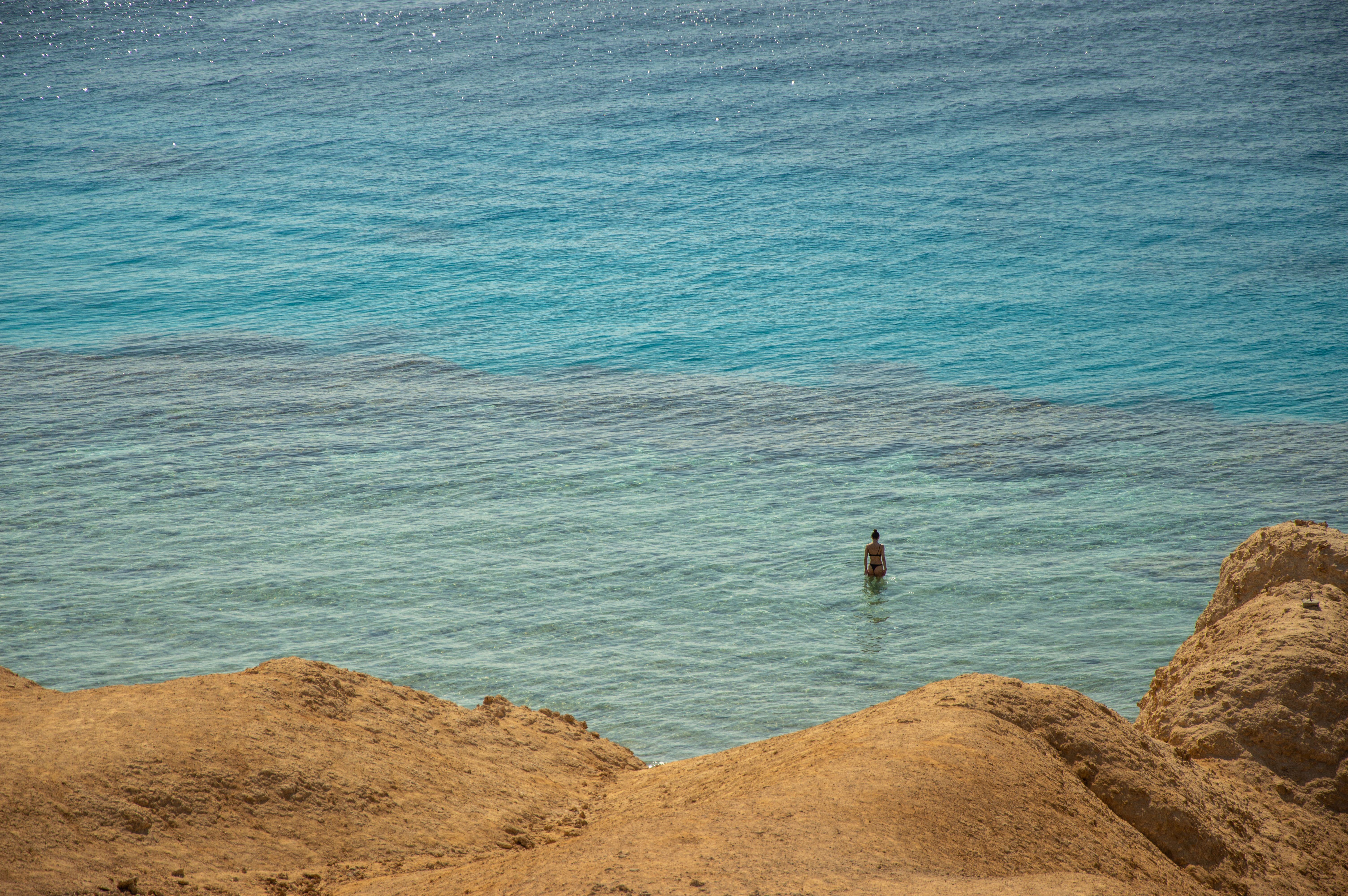 Woman standing in sea on shore, Djibouti