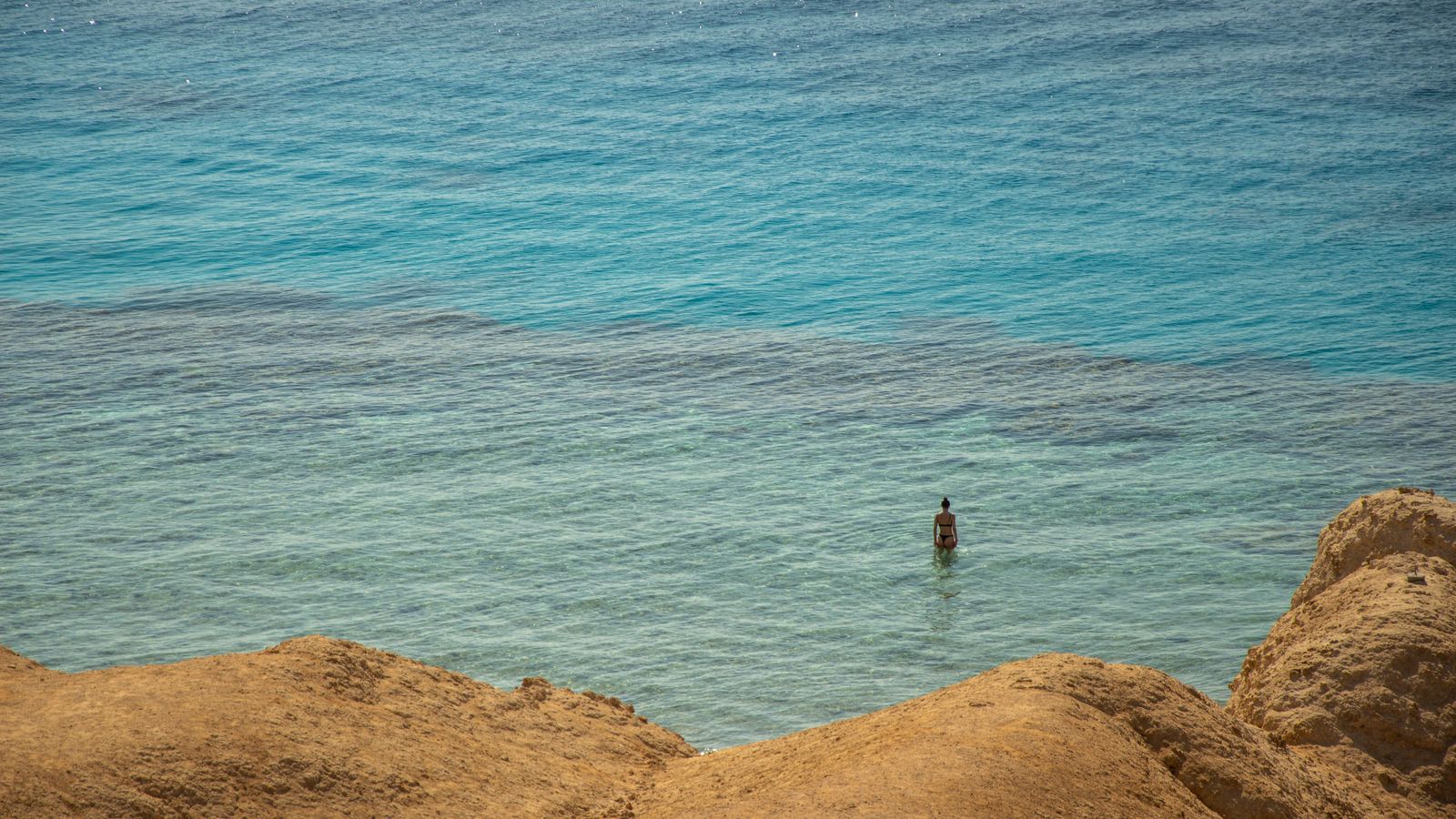 Woman standing in sea on shore, Djibouti