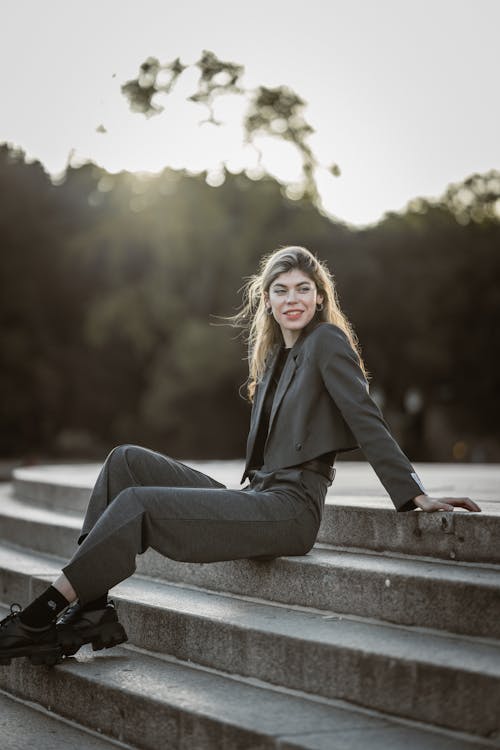 Blonde Woman Sitting in Gray Suit