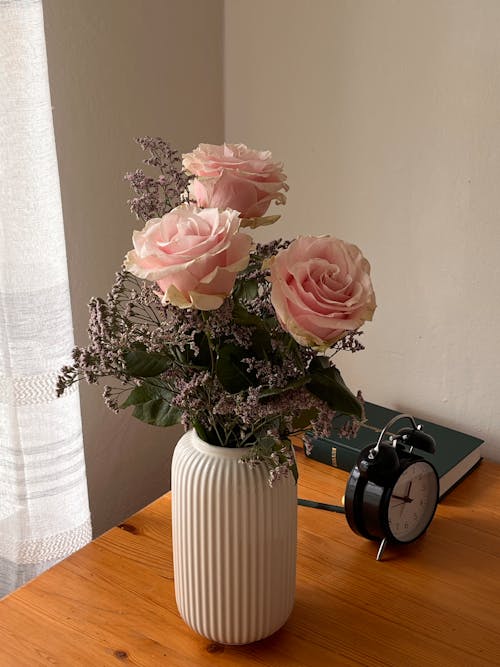 Bouquet of Large Pink Roses in a Vase on the Desk