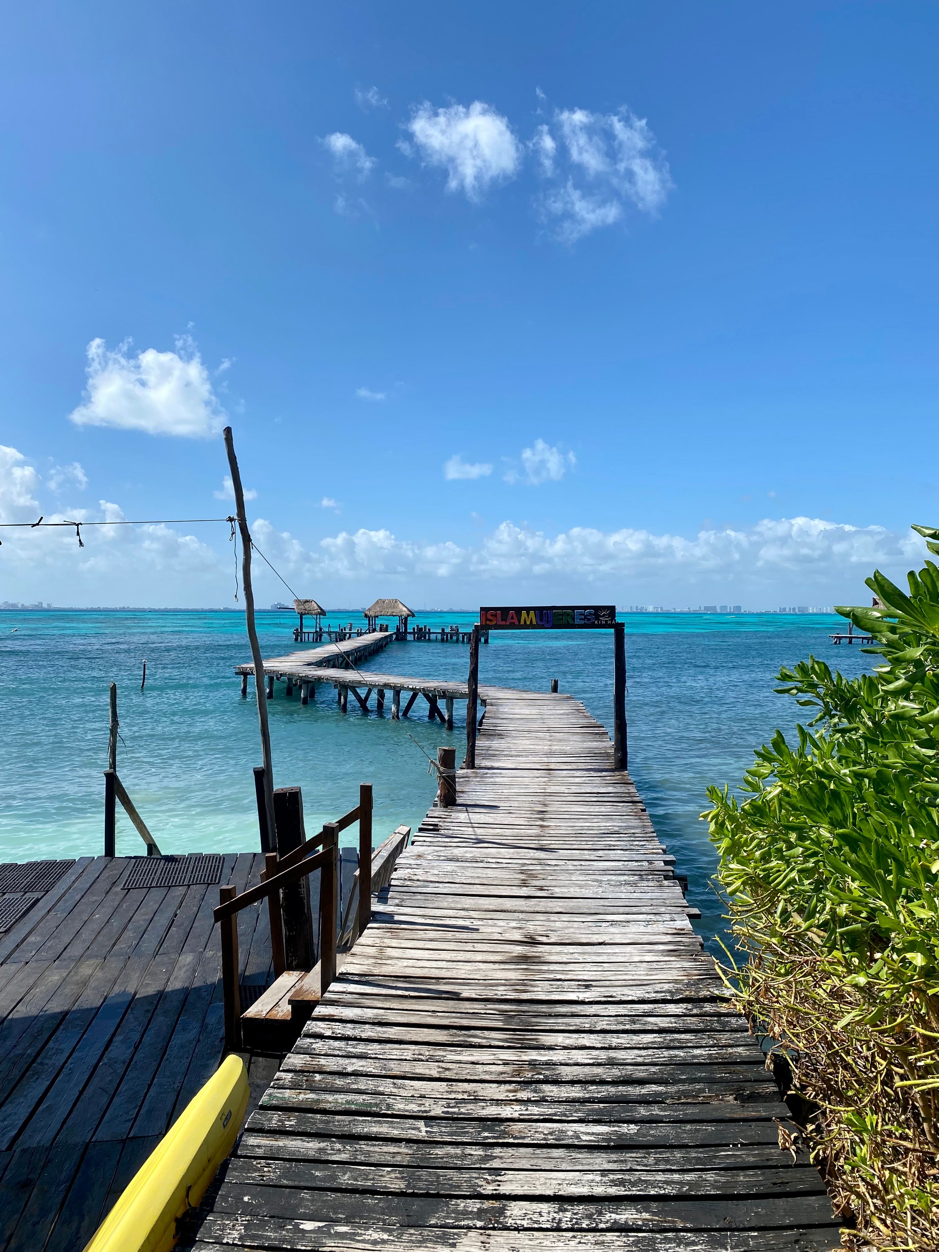 Wooden pier over turquoise water in Mexico near Isla Mujeres