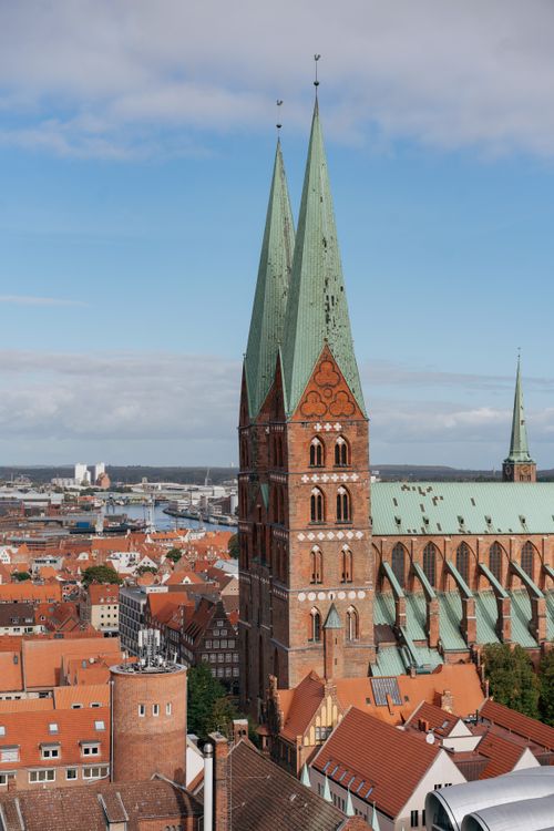Free Explore the stunning Gothic architecture of St. Mary's Church against Lübeck's charming cityscape. Stock Photo