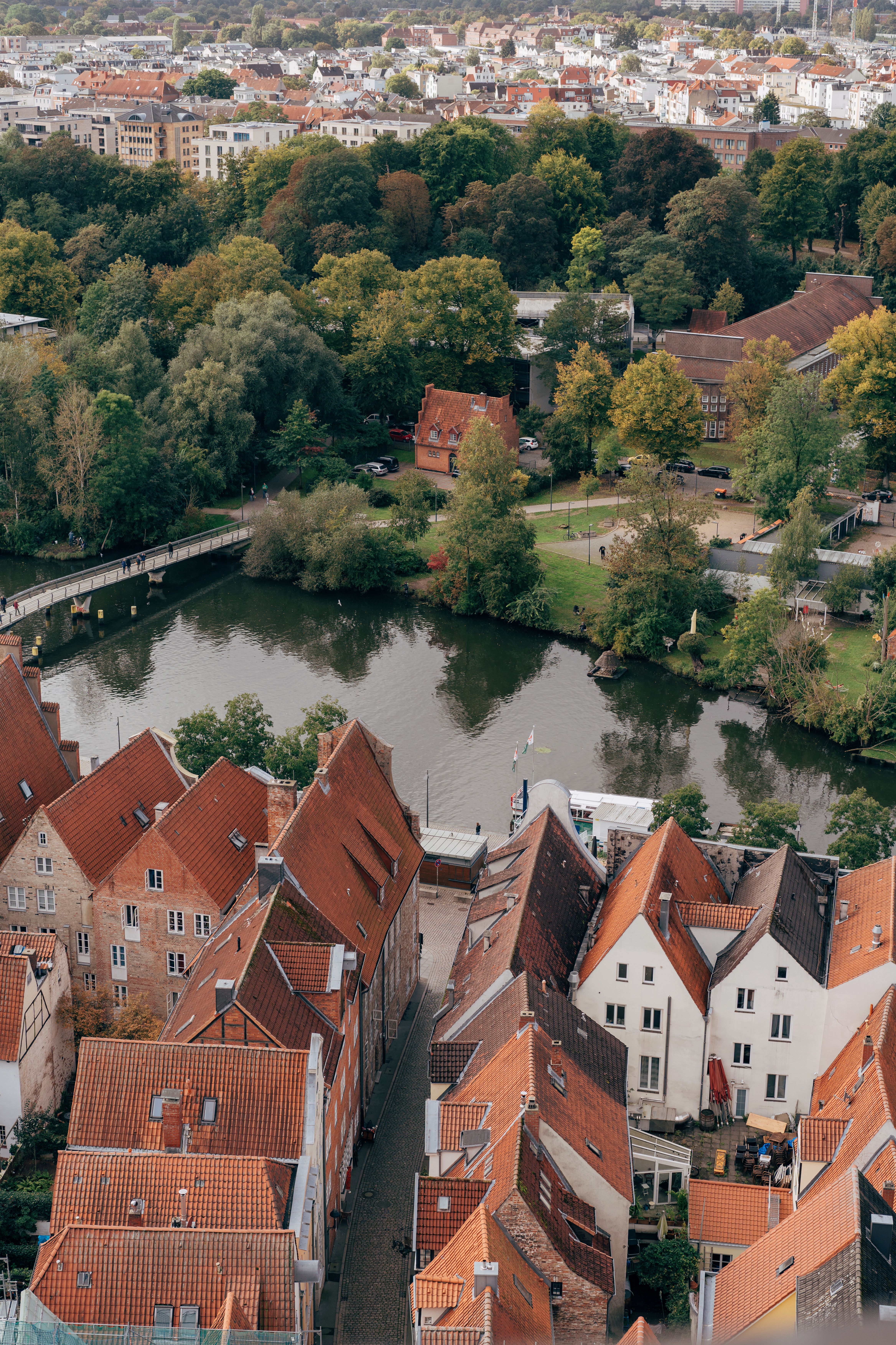 Free Aerial view of Lübeck's historic rooftops and scenic river, showcasing iconic German architecture. Stock Photo