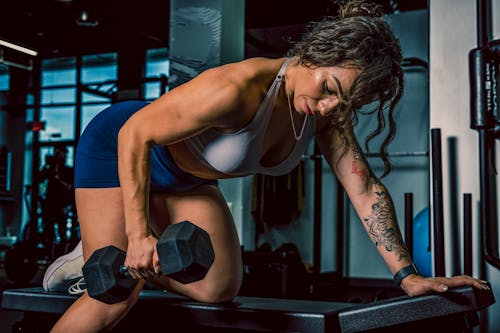 Free Woman Exercising with Dumbbell Stock Photo