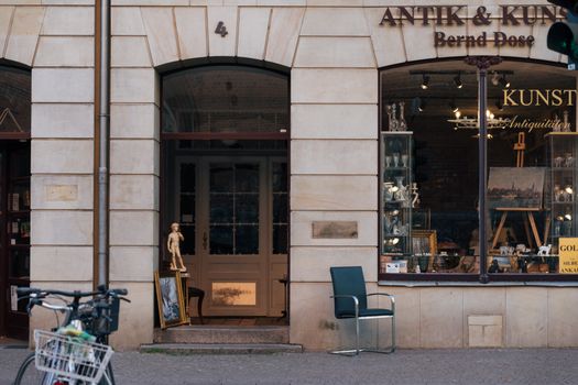 Entrance to an antique shop in Lübeck, showcasing vintage items and architecture.