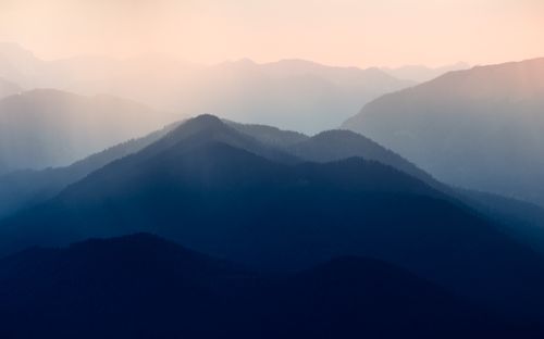 Free Peaceful view of misty mountain layers with soft morning light, creating a tranquil atmosphere. Stock Photo