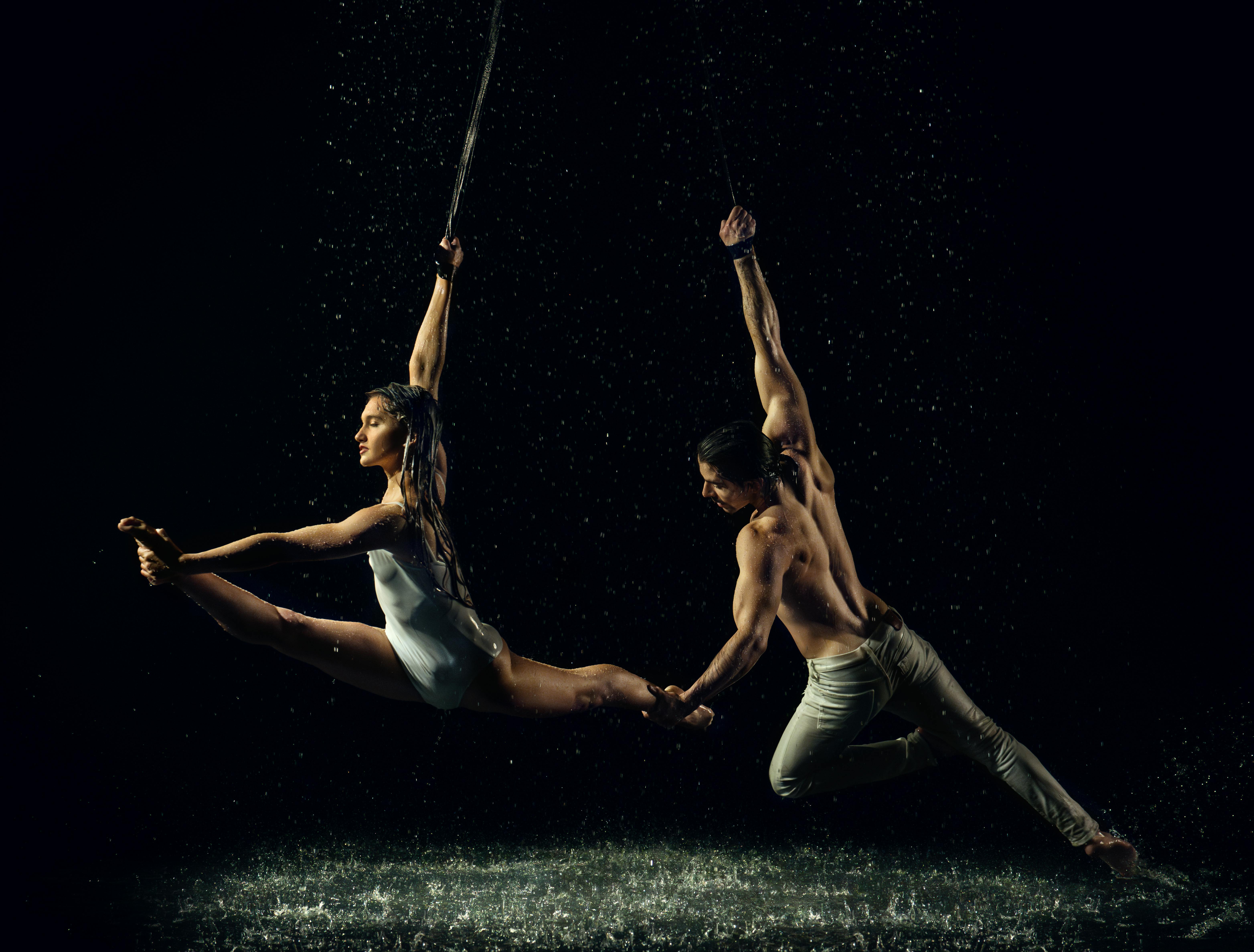 Two Ballet Dancers Dancing Suspended on Ropes under Rain · Free Stock Photo