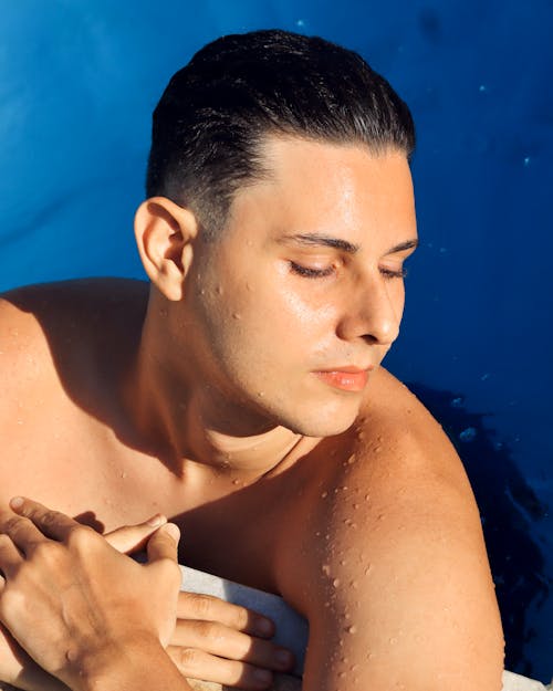 Young Man in a Swimming Pool with Eyes Closed 