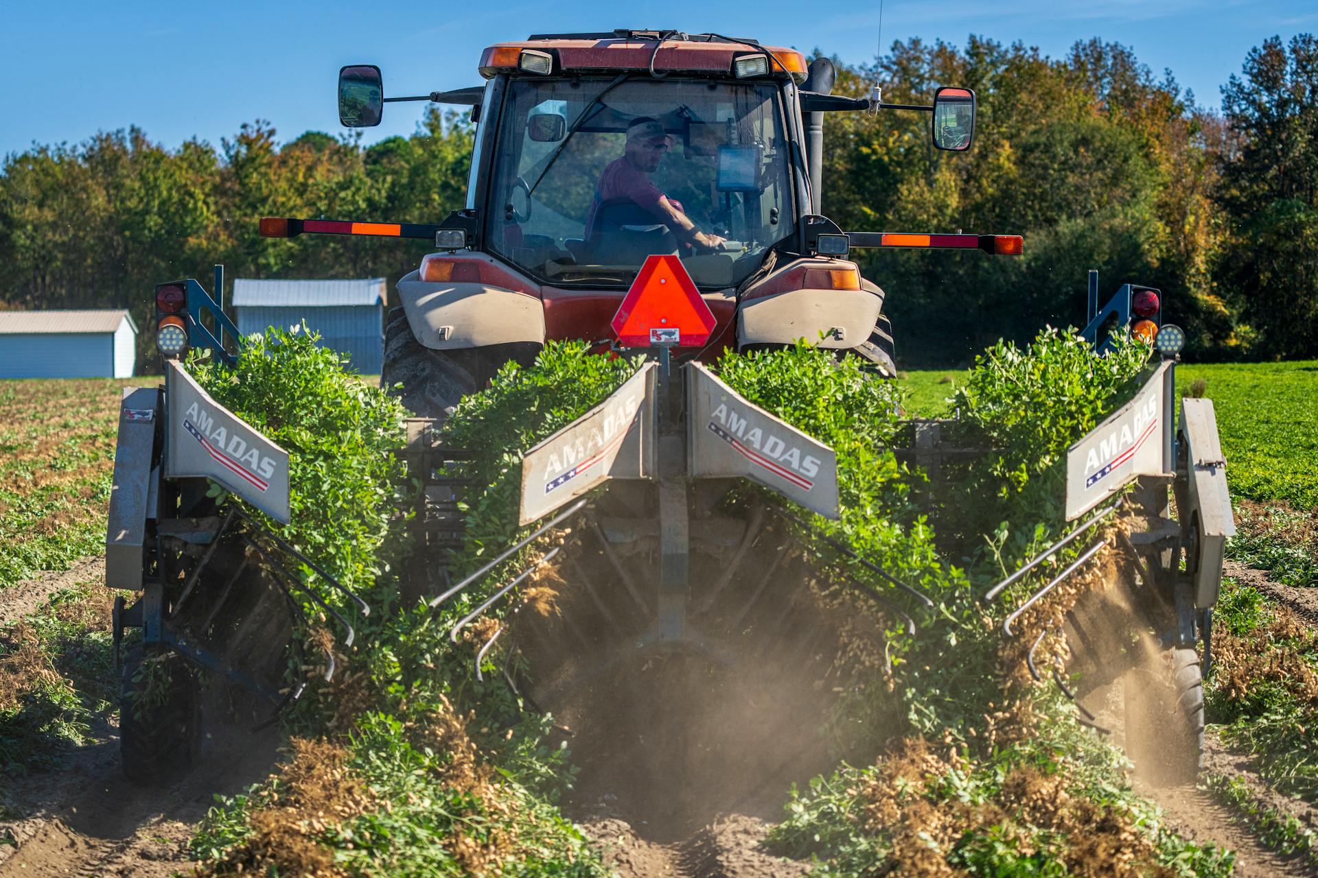 Farmer Plowing with Tractor on Field