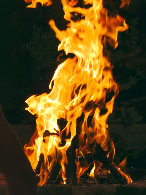 Free Close-up of vibrant flames engulfing wood, creating a warm and intense visual experience. Stock Photo