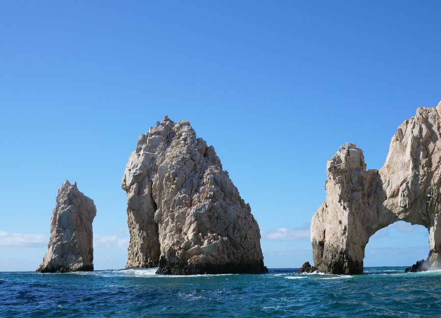 A breathtaking capture of El Arco rock formations in Cabo San Lucas against a clear sky.