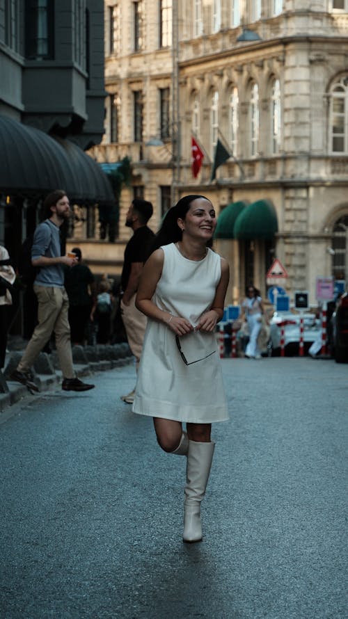 Woman Running in Dress on a Street