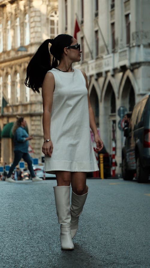 Woman in Sequin Dress and Boots on Street