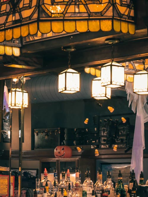 A bar with a large stained glass window and lights