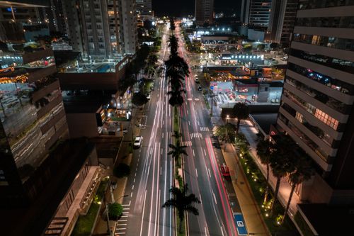 Free A vibrant aerial view of Londrina's illuminated city streets and modern architecture at night. Stock Photo