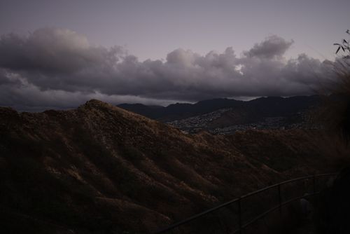 Free Scenic view of rugged Hawaiian hills with dramatic clouds at sunset. Stock Photo