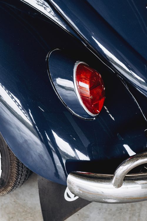 Free Rear view close-up of a classic vehicle's tail light and bumper. Stock Photo