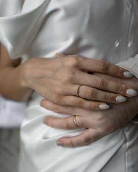 A touching close-up of newlyweds' hands adorned with wedding rings, signifying love and union.
