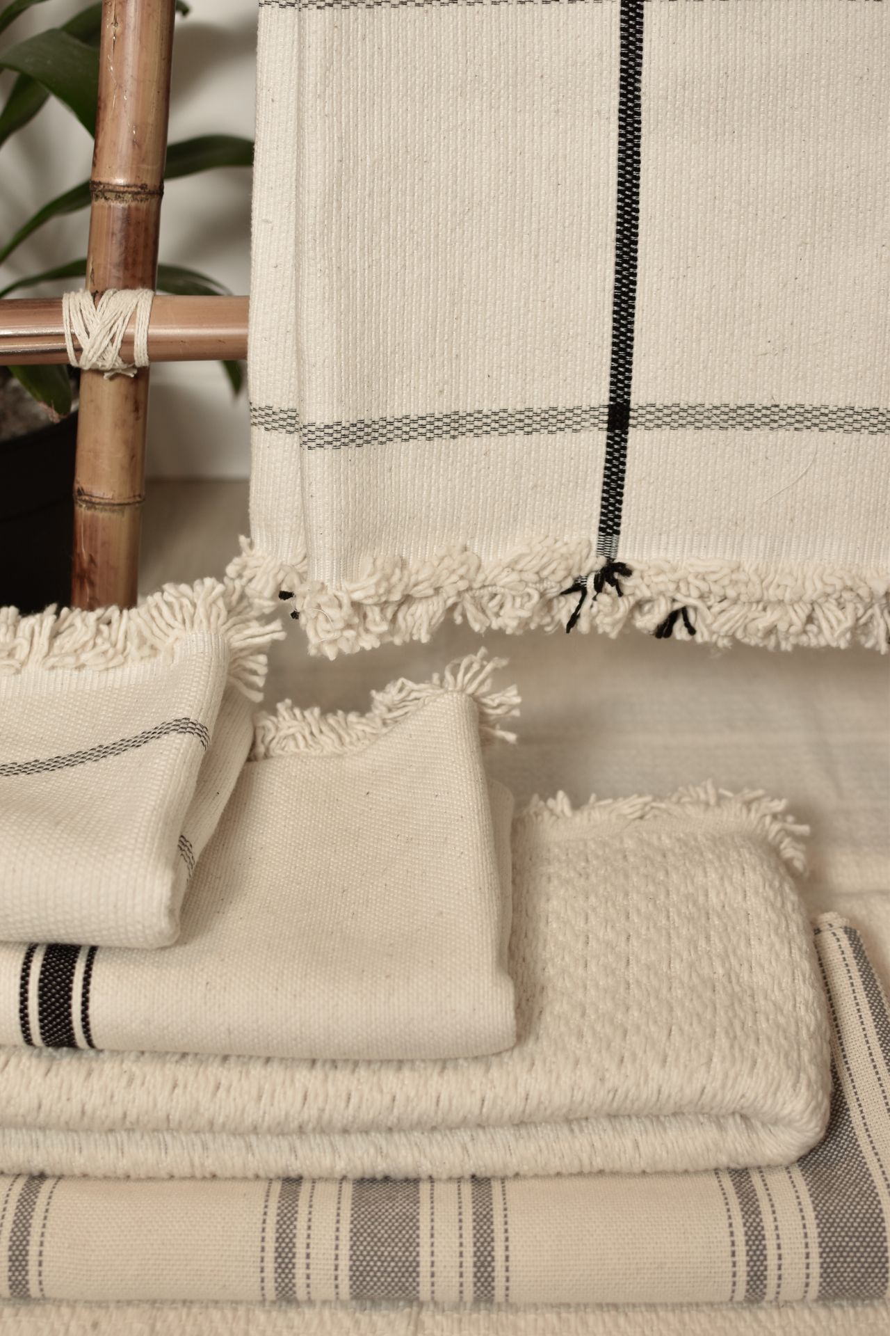 Neatly folded neutral throws stacked together