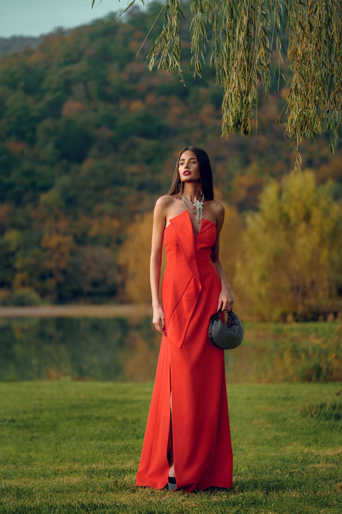 A woman in a red dress with a bag — styling the statement colour