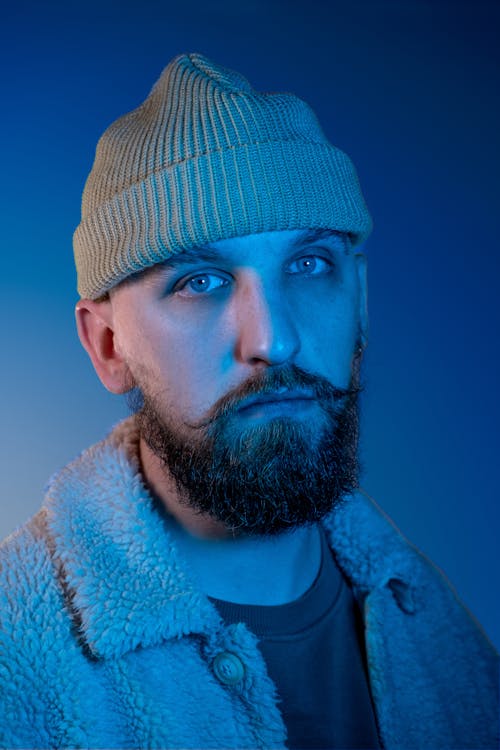 Studio Portrait of a Man with Mustache and Beard Wearing a Beanie 
