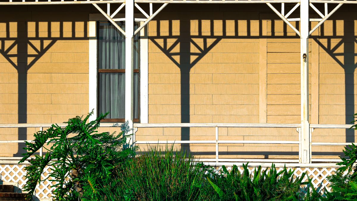 A house front with white railings. Space balusters evenly between the posts, not from one end.