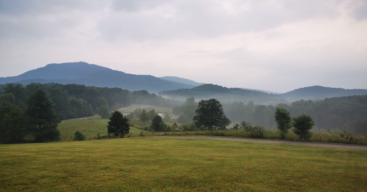 Peaceful misty morning view of rolling hills and mountains in rural North Carolina.