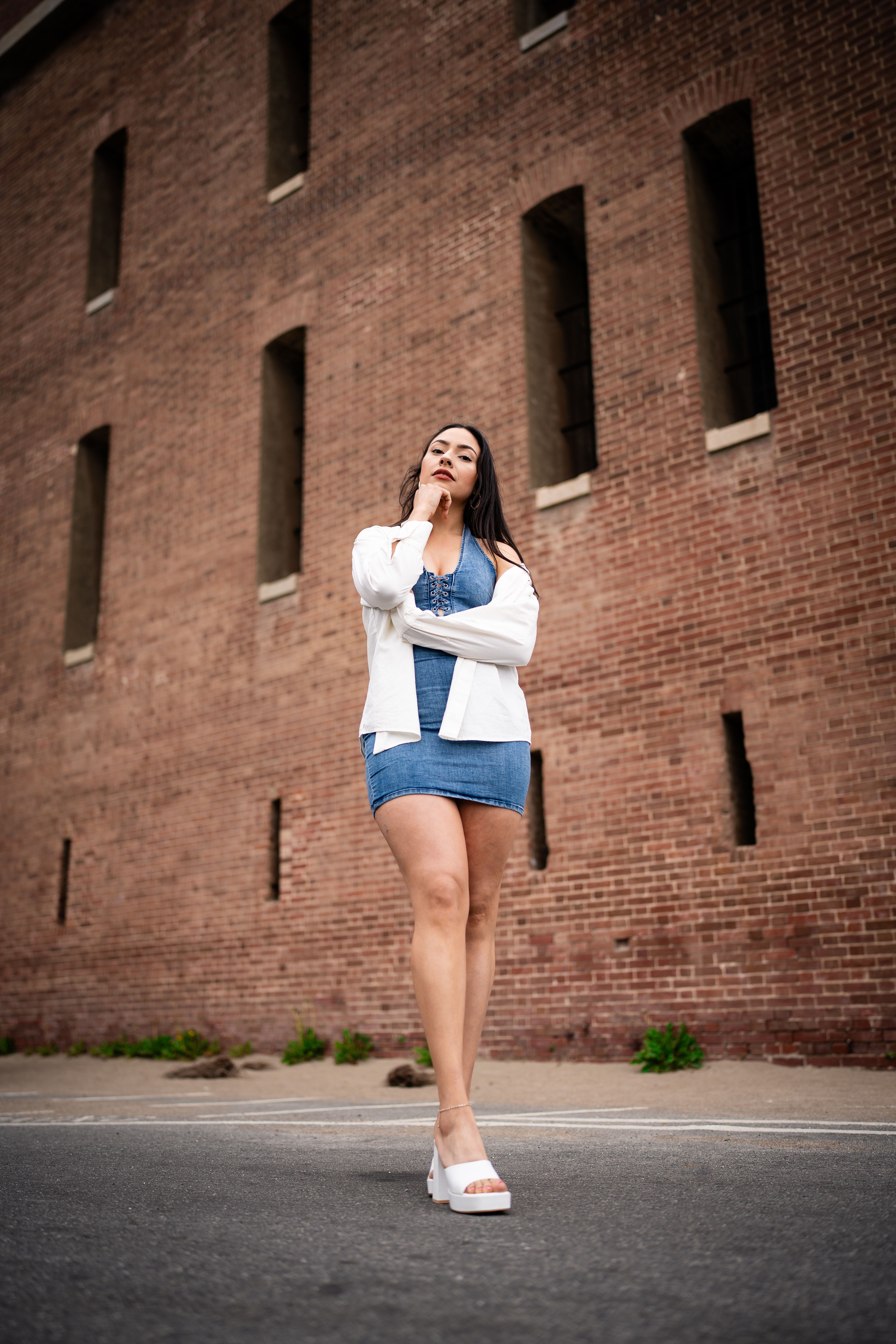 Young Woman in a Dress Standing in front of a Red Brick Building · Free ...