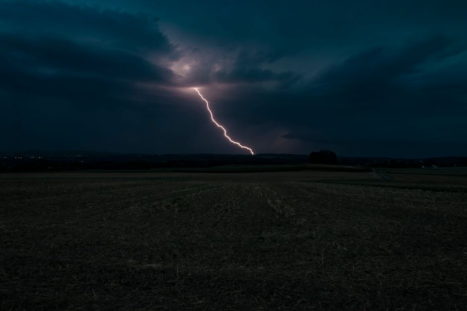 A striking lightning bolt lights up the night sky over a field in Aulendorf, Germany.