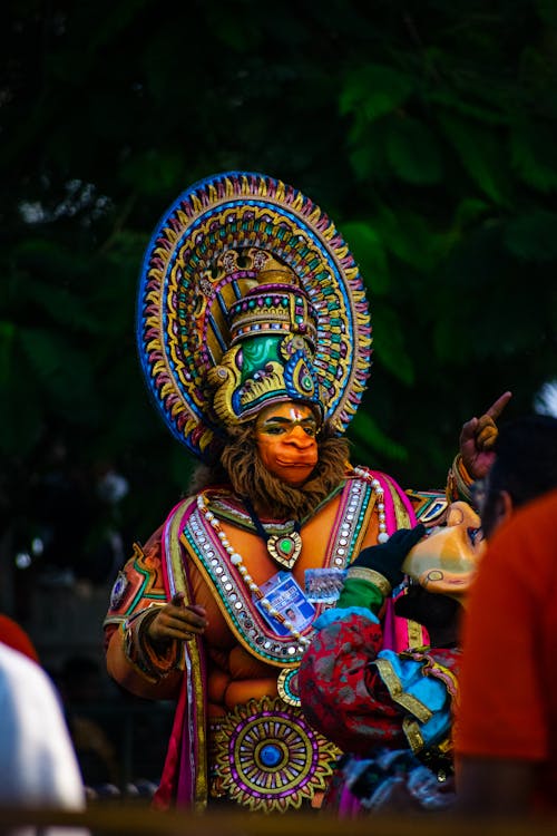 Person Dressed in a Colorful Costume at a Parade 