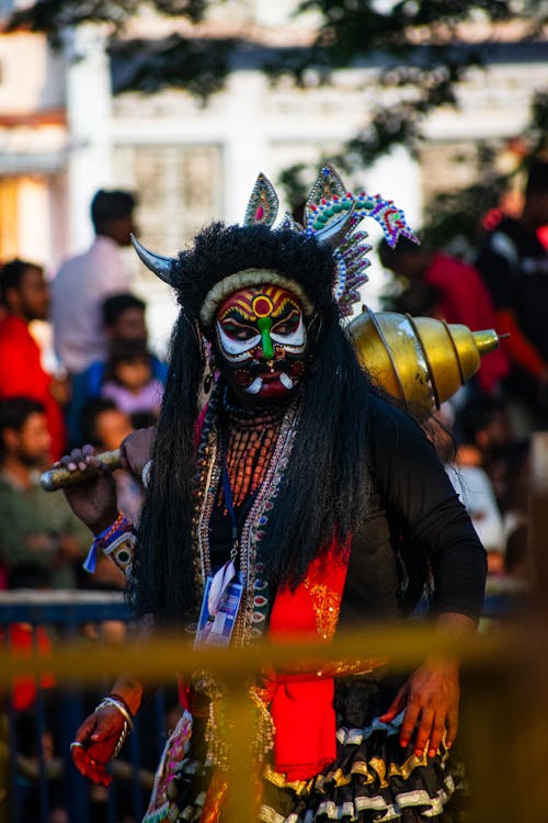 Man with a Face and Body Painting at a Festival 