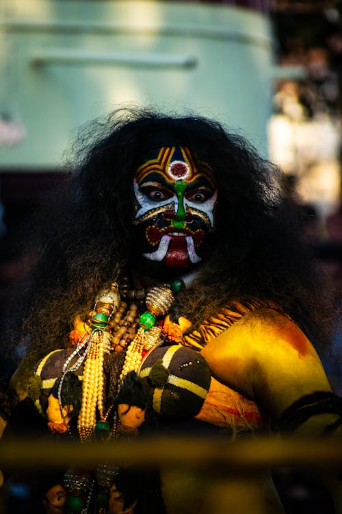 Man with a Face and Body Painting at a Festival 