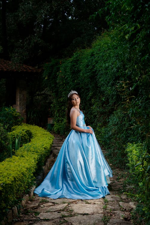 Woman Dressed as a Princess Standing on a Stone Path