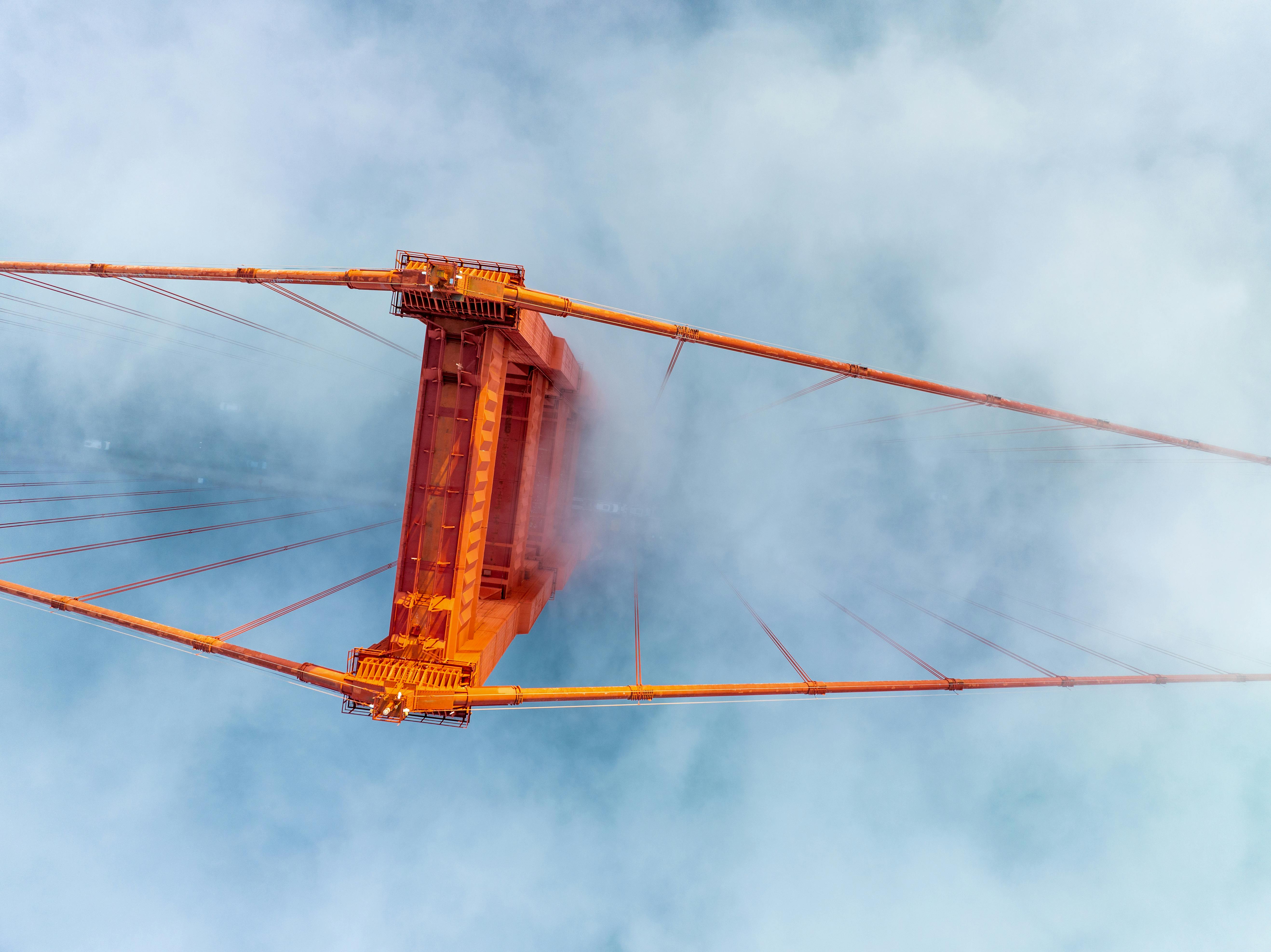 Stunning aerial shot of the Golden Gate Bridge emerging from the fog in San Francisco.