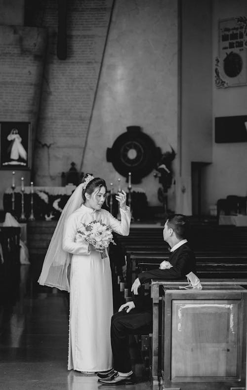 Bride and Groom Talking Inside a Church 