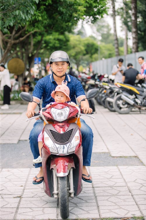 Man with a Baby on a Motor Scooter 