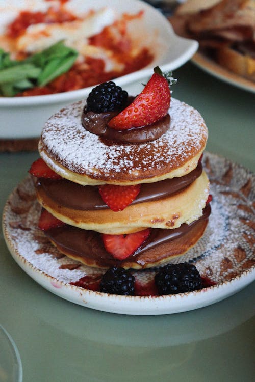 Pile on Pancakes with Sugar Powder, Chocolate and Fruits