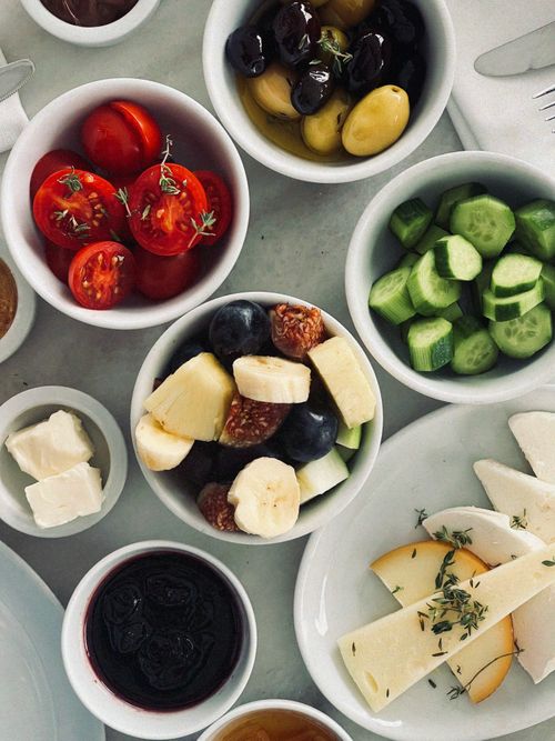 Free A vibrant array of fresh fruits, vegetables, and cheese in bowls for a healthy meal. Stock Photo