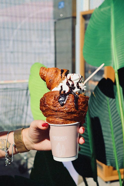 Woman Holding a Cup with Ice-Cream Croissant Dessert