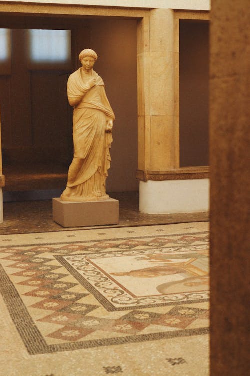 Mosaic on Floor and Sculpture behind in Museum