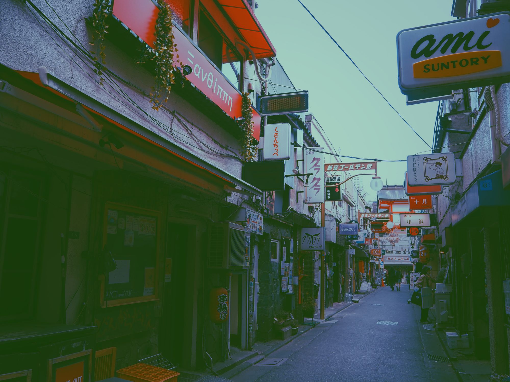 Explore a vibrant, narrow street lined with signs and traditional architecture under clear skies in Japan