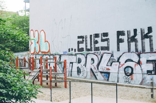 White Red and Blue Graffiti on White Wall